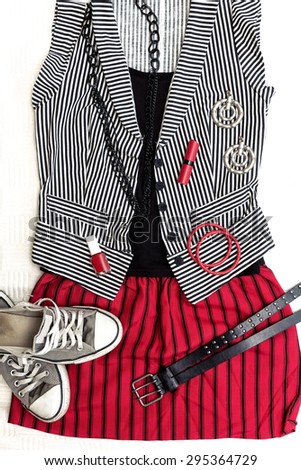 Punk / rock fashion outfit. Black, white and red clothes, accessories and sneakers. Top view.