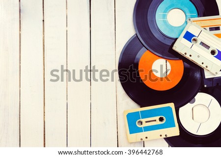 Top view of  audio cassettes and gramophone records with negative space.