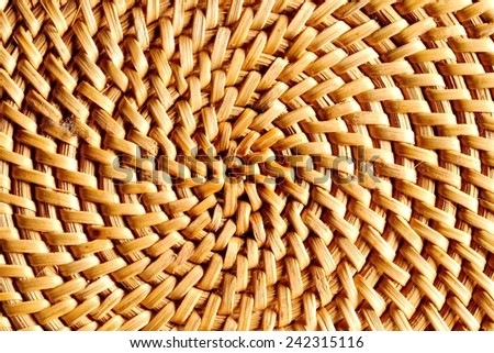 Hand-woven wicker surface, warm colors.