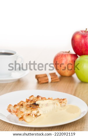 Easy layout of an apple crumble dessert with vanilla custard with a shallow depth of field.
