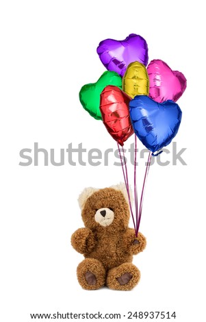 Teddy bear holds many helium gas filled colored heart balloons for saint valentine\'s day, birthday or other celebration. With pure white background to use as you wish.