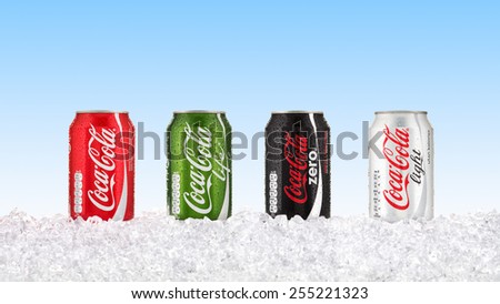 Goteborg, Sweden - Feb 15, 2015: Four kinds of pure Coca Cola soft drink in aluminum cans standing on a illustrated bed of ice with with a blue toning summer sky in the background.