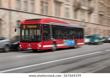 Stockholm, Sweden - March 31, 2015: Classic red buses in the public transportation system in the city of Stockholm with motion blur.