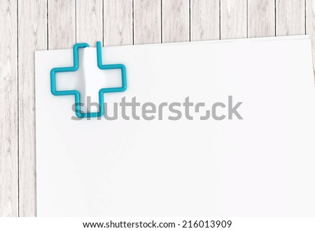 Medical document template with blue cross paper clip on white wood desk - ilustration clipping path