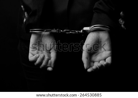Woman hands in handcuffs (close-up)