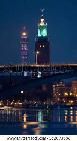 Night lights reveal two towers in Stockholm city center - the new tower - the TV tower Kaknastornet and the old tower - Stockholm City Hall tower behind the western bridge.