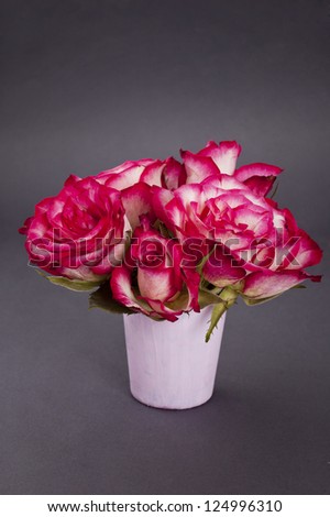 pink box and bouquet of red roses in pot