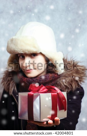 winter girl with gift box. gift in the focus