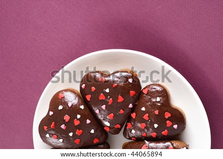 chocolate heart shape cakes on purple background