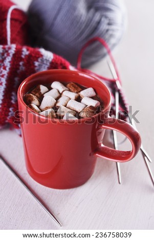 mug with hot chocolate and handmade knitting sock