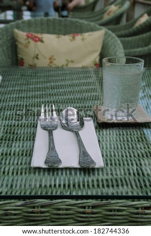 Silverware or flatware set of fork and spoonon rattan table,vintage