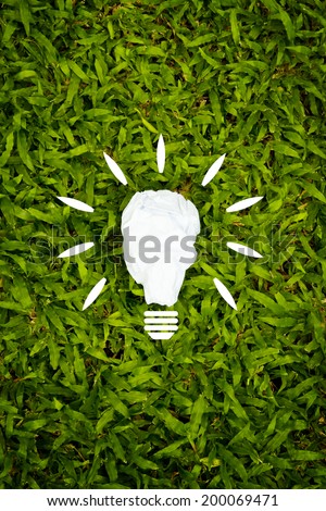 Eco concept, light bulbs paper model on the grass.