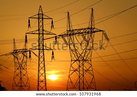 group of high voltage pole against sun