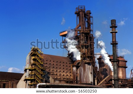 old steel factory with smoke