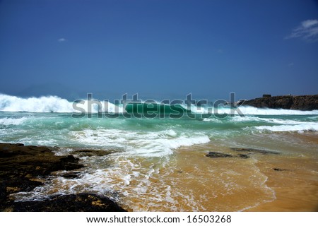 beach with sand,clean water and huge waves
