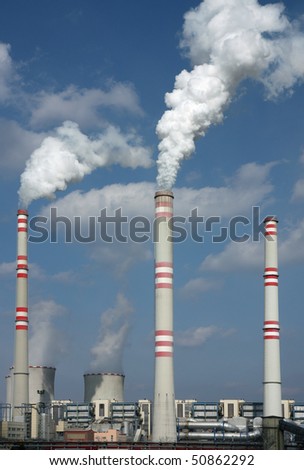 detail of coal power plant with chimney and cooling towers