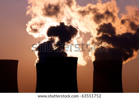 smoking cooling towers  during sunset
