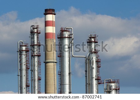 silver steel and concrete  chimney of oil refinery