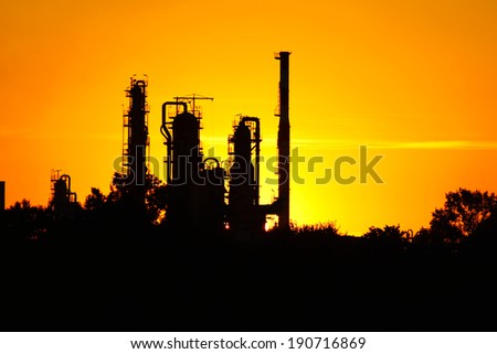 silhouette of  oil refinery factory  against sunset