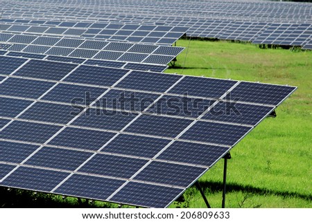 huge field of solar power panels on meadow