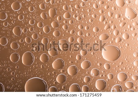 Clear brown water drops over brown background