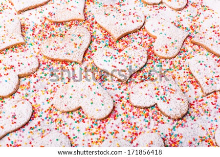Biscuits strewed by powdered sugar and multicolor decorations