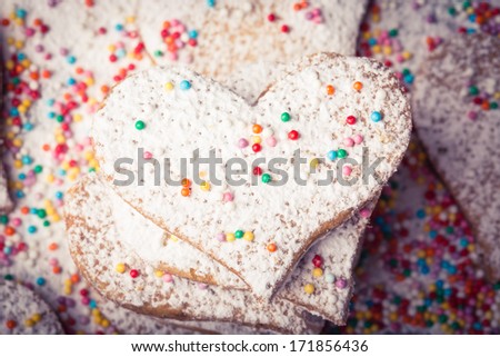Biscuits strewed by powdered sugar and multicolor decorations