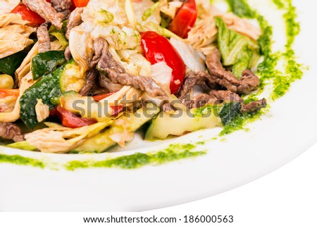 Asian spicy salad with meat, cucumbers and other vegetables