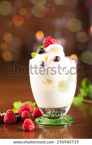 Delicious bowl of melted ice cream with berries
