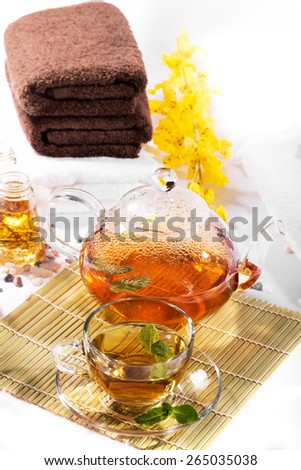 SPA still life: green tea, aromatic oil, towels: green tea, aromatic oil, towels