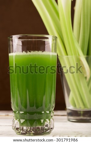 Glass of celery juice on the white table