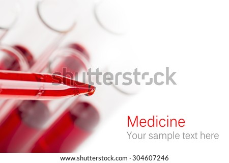 Pipette with drop of blood and test tubes