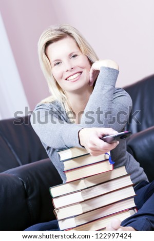 Beautiful blonde woman in the book is based on the remote control in his hand.
