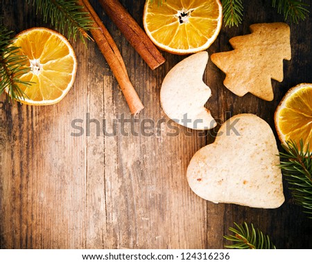 Festive cakes and orange circles on a rustic wooden table.