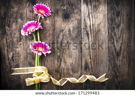 Gerbera flower ribbon rustic wood planks.
