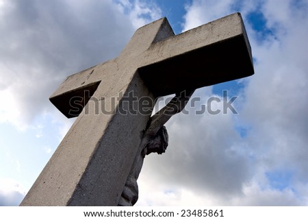 Crucifix Jesus, background blue havens clouds.