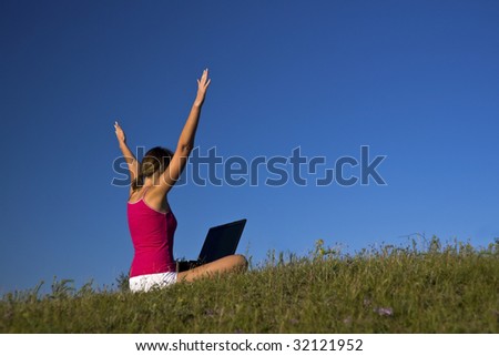 Beautiful young woman using a laptop, and happy.