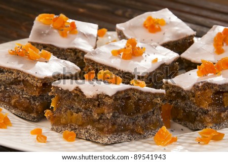 Poppy seed cake in the offering plate, decorated with orange.
