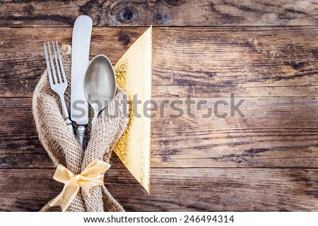 Old ornate wooden board with cutlery.