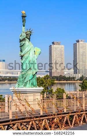 Lady liberty juxtaposed against Rainbow Bridge in Tokyo, Japan.