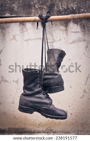 pair of  old boot hang on bamboo, process color