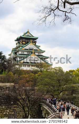 OSAKA, JAPAN- APR 12: Tourists visit Osaka castle in Osaka city, Japan on April 12, 2015. The castle is one of Japan most famous and it played a major role in the unification of Japan.