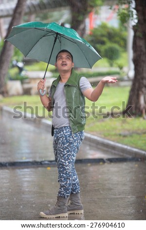 Rainy day - young man with umbrella