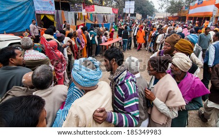 BABUGHAT, KOLKATA, WEST BENGAL / INDIA - 12TH JANUARY 2014 : Hindu devotees qued up for food in winter morning at Babughat transit camp, The devotees are on their way to Holy place Gangasagar (Sagar).
