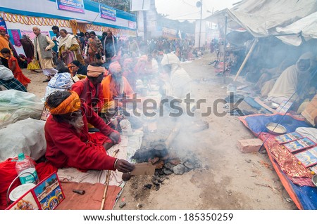 BABUGHAT, KOLKATA, WEST BENGAL / INDIA - 12TH JANUARY 2014 : Sadhus (Hindu Saints) and holy smoke , in Babughat transit camp, Kolkata. They are on their way to Holy place Gangasagar (Sagar).