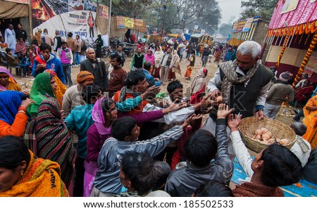 BABUGHAT, KOLKATA, WEST BENGAL / INDIA - 12TH JANUARY 2014 : Tea is being distributed among Hindu Devotees in winter morning at Babughat transit camp, Kolkata. They are on their way to Gangasagar.