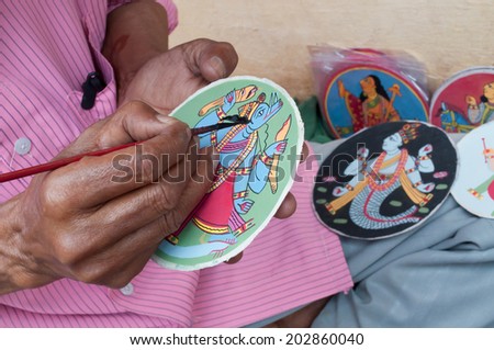 BISHNUPUR, WEST BENGAL / INDIA - OCTOBER 24, 2013: Artisan making Dashavatara cards. They are famous artwork, depicting ten Avataras of God Vishnu, as mentioned in the Puranas, Hindu religious text.