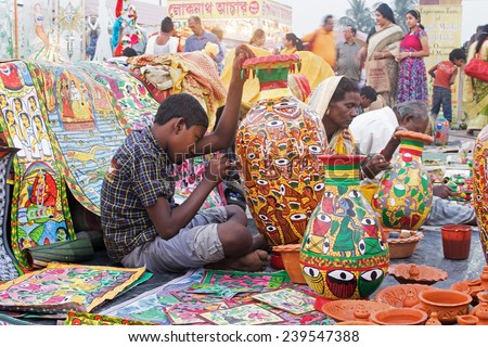 KOLKATA, WEST BENGAL , INDIA - NOVEMBER 23RD 2014 : Unidentified artists painting furniture, handicrafts show during Handicraft Fair in Kolkata - the biggest handicrafts fair in Asia.