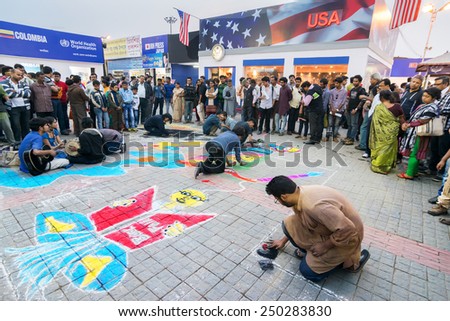 KOLKATA, INDIA - FEBRUARY 5TH : Young artists painting floor at Kolkata book fair, on February 5th, 2015 in Kolkata. It is world's largest, most attended and famous non-trade book fair.