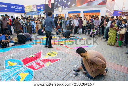 KOLKATA, INDIA - FEBRUARY 5TH : Young artists painting floor at Kolkata book fair, on February 5th, 2015 in Kolkata. It is world\'s largest, most attended and famous non-trade book fair.